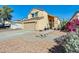 Inviting two-story home with a two-car garage, desert landscaping, and a tidy front yard at 4050 W Camino Del Rio --, Glendale, AZ 85310