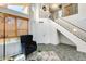 Bright foyer with high ceilings, a staircase, neutral decor, and a comfortable seating area at 4050 W Camino Del Rio --, Glendale, AZ 85310