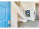 Bright foyer with staircase, tile flooring, and a decorative art piece, offering a grand entrance to the home at 4050 W Camino Del Rio --, Glendale, AZ 85310