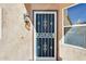 Charming front door with decorative security screen, sidelight window, and stylish outdoor lighting, creating a welcoming entrance at 4050 W Camino Del Rio --, Glendale, AZ 85310