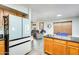 Bright kitchen features a modern, blue-paneled refrigerator and wood cabinets with granite countertops at 4050 W Camino Del Rio --, Glendale, AZ 85310