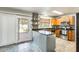 Updated kitchen with stainless steel appliances, wood cabinetry, granite counters, modern backsplash, and a breakfast bar at 4050 W Camino Del Rio --, Glendale, AZ 85310