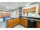 Modern kitchen with granite countertops, wood cabinetry, stainless appliances, and ample natural light at 4050 W Camino Del Rio --, Glendale, AZ 85310