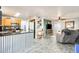 Open floor plan showing the kitchen and living room with tile floors and modern decor at 4050 W Camino Del Rio --, Glendale, AZ 85310