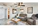 Inviting living room with a comfortable sofa and a modern ceiling fan at 4050 W Camino Del Rio --, Glendale, AZ 85310