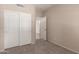 This is a cozy bedroom features neutral walls and carpet with a closet perfect for a restful retreat at 4176 E Bonanza Rd, Gilbert, AZ 85297