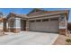 View of a large two-car garage with decorative windows above the doors at 4176 E Bonanza Rd, Gilbert, AZ 85297