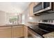 Kitchen with stainless steel oven, microwave and stone counter tops overlooking living area and backyard at 4176 E Bonanza Rd, Gilbert, AZ 85297