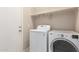 Functional laundry room equipped with appliances and storage, simplifies chores at 4176 E Bonanza Rd, Gilbert, AZ 85297