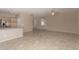 Open-concept living room and kitchen with stainless steel appliances and tile floors at 4176 E Bonanza Rd, Gilbert, AZ 85297