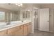 Primary bathroom featuring double sinks, a large mirror, and private water closet at 4176 E Bonanza Rd, Gilbert, AZ 85297