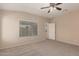 Bright primary bedroom featuring large windows and neutral carpeting at 4176 E Bonanza Rd, Gilbert, AZ 85297