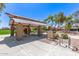 Shaded park pavilion featuring picnic tables, lush landscaping, and manicured lawn at 4176 E Bonanza Rd, Gilbert, AZ 85297