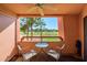 View from the balcony overlooking golf course, complete with table and chairs and a ceiling fan at 4303 E Cactus S Rd # 329, Phoenix, AZ 85032