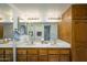 Bathroom featuring double sinks, vanity cabinets, and a large mirror at 4303 E Cactus S Rd # 329, Phoenix, AZ 85032