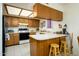 Functional kitchen with wood cabinets, white countertops, and essential appliances at 4303 E Cactus S Rd # 329, Phoenix, AZ 85032