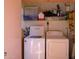Bright laundry room with washer, dryer, shelving, and storage for laundry necessities at 4303 E Cactus S Rd # 329, Phoenix, AZ 85032