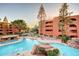 Community pool area surrounded by desert landscaping and multi-story buildings at 4303 E Cactus S Rd # 329, Phoenix, AZ 85032