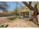 Spacious backyard with a covered patio, mature trees, and xeriscaping at 4310 E Palo Brea Ln, Cave Creek, AZ 85331