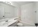 Bright white bathroom featuring a shower-tub combo, large mirror, and modern vanity at 4310 E Palo Brea Ln, Cave Creek, AZ 85331