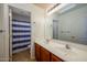 Bright bathroom features a double vanity, toilet and shower with a blue and white shower curtain at 4415 E High Point Dr, Cave Creek, AZ 85331