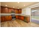 Well-equipped kitchen with granite countertops, stainless steel appliances, and wood-look tile flooring at 4415 E High Point Dr, Cave Creek, AZ 85331