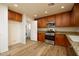 This kitchen includes stainless steel appliances, wood cabinets and direct access to the laundry room at 4415 E High Point Dr, Cave Creek, AZ 85331