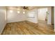Open-concept living area with wood-look tile, ceiling fan, and a pass-through counter to kitchen at 4415 E High Point Dr, Cave Creek, AZ 85331