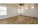 Spacious living room with wood-look tile flooring, ceiling fan, and multiple windows at 4415 E High Point Dr, Cave Creek, AZ 85331