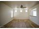 Spacious living room with wood-look tile flooring, ceiling fan, and pass-through counter at 4415 E High Point Dr, Cave Creek, AZ 85331
