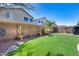 Backyard featuring artificial turf, desert landscaping, and block fencing at 44235 W Mcclelland Dr, Maricopa, AZ 85138
