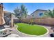 Landscaped backyard featuring artificial turf, desert landscaping, and a patio at 44235 W Mcclelland Dr, Maricopa, AZ 85138