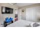 Comfortable bedroom with a mounted TV, closet, and a blue rocking horse at 44235 W Mcclelland Dr, Maricopa, AZ 85138