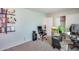 Cozy bedroom with a desk, carpeted floors, built-in shelving, and ample closet space at 44235 W Mcclelland Dr, Maricopa, AZ 85138