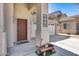 Inviting front porch area featuring a metal decorative art and view of two-car garage at 44235 W Mcclelland Dr, Maricopa, AZ 85138