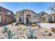 Charming home with desert landscaping and a two-car garage, showcasing curb appeal and easy maintenance at 44235 W Mcclelland Dr, Maricopa, AZ 85138