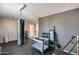 Spacious home gym featuring a heavy bag, weights, and exercise equipment for a complete workout at 44235 W Mcclelland Dr, Maricopa, AZ 85138