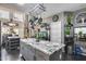 Spacious kitchen with a granite island, stainless steel appliances, and an adjacent dining and living area at 44235 W Mcclelland Dr, Maricopa, AZ 85138