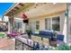 Covered patio featuring a fire pit, lounge area, and a hanging swing at 44235 W Mcclelland Dr, Maricopa, AZ 85138