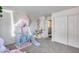 Bright playroom with a baby swing, slide, and closet for toy storage at 44235 W Mcclelland Dr, Maricopa, AZ 85138