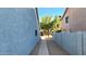 View of a backyard pathway between two houses at 444 W Fabens Ln, Gilbert, AZ 85233