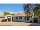 Large backyard with a covered patio, desert landscaping, and block fencing for privacy at 444 W Fabens Ln, Gilbert, AZ 85233