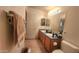 Bathroom with dual sinks, tile floors, and framed mirrors at 444 W Fabens Ln, Gilbert, AZ 85233
