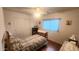 Inviting bedroom with wood floors, a ceiling fan, and natural light creating a relaxing and comfortable personal space at 444 W Fabens Ln, Gilbert, AZ 85233