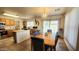 Bright dining area features a wooden table, chairs with blue fabric, and direct access to the backyard through a sliding door at 444 W Fabens Ln, Gilbert, AZ 85233
