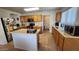 Functional kitchen with oak cabinets, an island, and stainless appliances providing a practical and stylish cooking space at 444 W Fabens Ln, Gilbert, AZ 85233