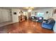Spacious living room with wood floors and large windows offering natural light at 444 W Fabens Ln, Gilbert, AZ 85233