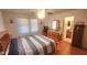 Bright bedroom with wood floors, ceiling fan, and a bathroom ensuite at 444 W Fabens Ln, Gilbert, AZ 85233