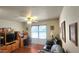 Comfortable home office with a wooden desk, built-in shelving unit, and a cozy seating area by the window at 444 W Fabens Ln, Gilbert, AZ 85233