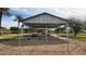 Swing set, picnic area, and shade structure in a community park at 444 W Fabens Ln, Gilbert, AZ 85233